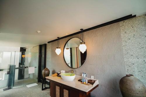 a bathroom with a sink and a mirror on the wall at Javana Royal Villas in Seminyak