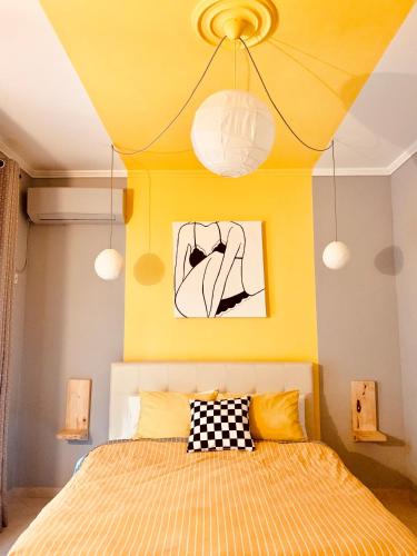 a bedroom with a bed with a yellow ceiling at Family Tree - WATER Available - SELF check in in Golem