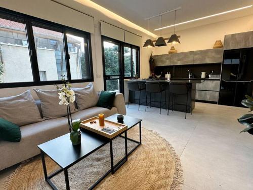 a living room with a couch and a table at A luxury apartment in the Neve Tzedek neighborhood in Tel Aviv