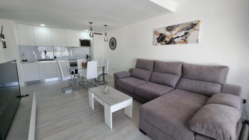 a living room with a couch and a table at Casilla de Costa Luxury home in La Oliva