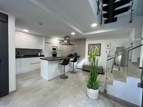 a kitchen with a counter and a table in it at Casa de Recreo in Benajarafe