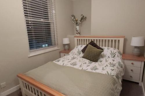 a bedroom with a bed and a window at Stylish Town House in Medieval Grid in Bury Saint Edmunds