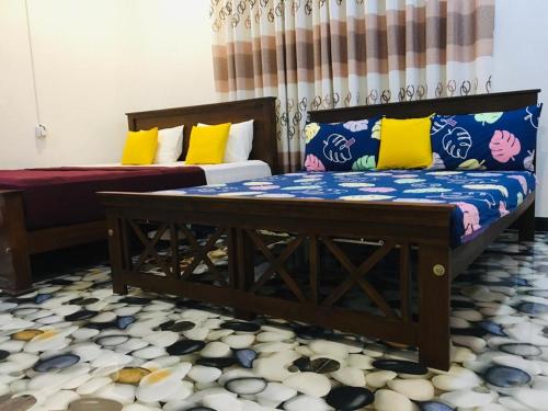 a living room with two beds and a couch at Vihanga Guest House in Habarana