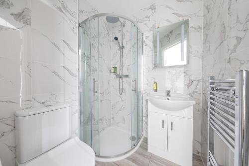 a bathroom with a shower and a sink and a mirror at Cozy Ensuite Bedroom for Two near Tufnell Park in London