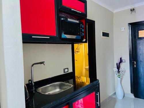 a bathroom with a sink and a microwave on a wall at Porto marina chalet and apartment in El Alamein