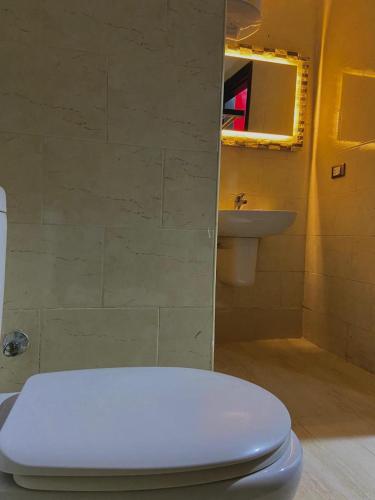 a bathroom with a white toilet and a sink at Porto marina chalet and apartment in El Alamein
