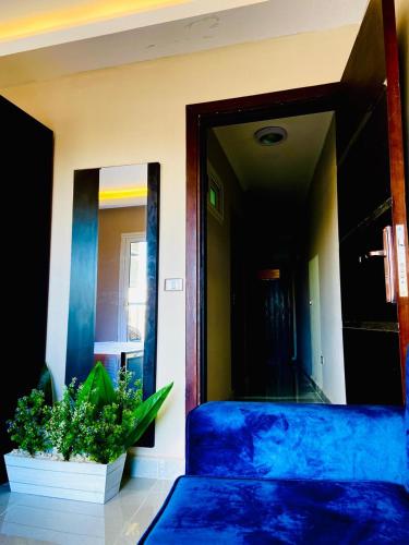 a bedroom with a blue bed and a mirror at Porto marina chalet and apartment in El Alamein