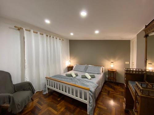 サンタ・フラーヴィアにあるCasa Panoramica Mongerbinoのベッドルーム1室(ベッド1台、椅子付)