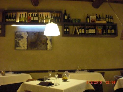 a dining room with two tables with white tablecloths at Hotel Le Capanne in Arezzo