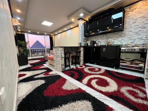 a living room with a red and black carpet at Hi Pyramids in Cairo