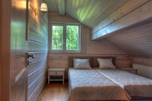 a small bedroom with a bed and a window at Villa Pillapalu in Pillapalu