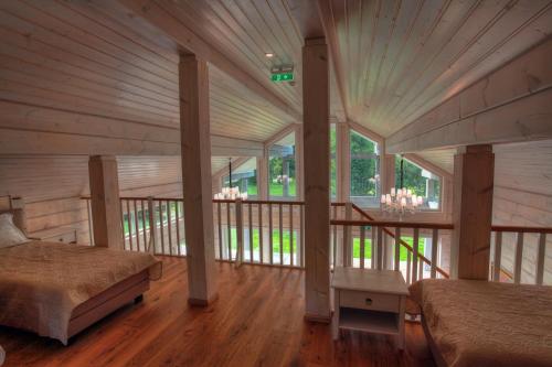 a large room with two beds and a balcony at Villa Pillapalu in Pillapalu