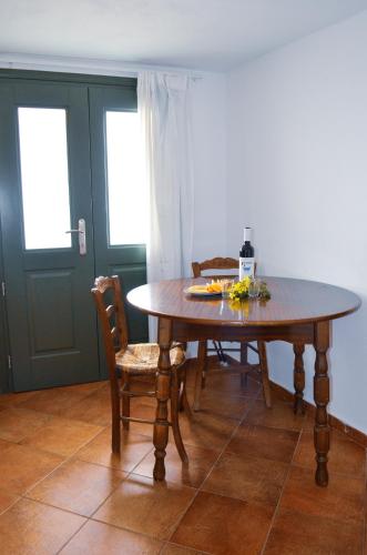 a dining room table with two chairs and a table with flowers on it at Bluegonia in Éxo Goniá