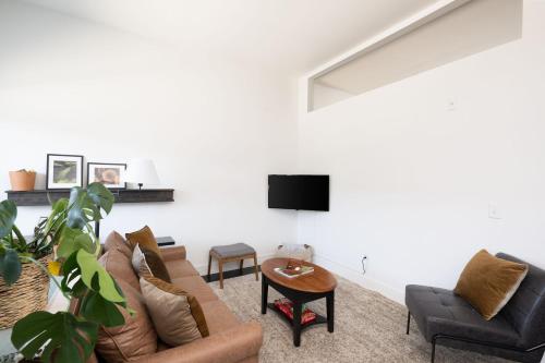 a living room with a couch and a tv at Flexhome Skywalk to Fiserv 1BR Apt U6 - READ INFO in Milwaukee