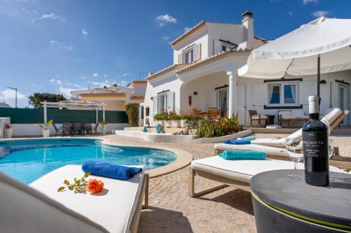 a villa with a swimming pool and a house at Lagos - Pool & Garden in Lagos