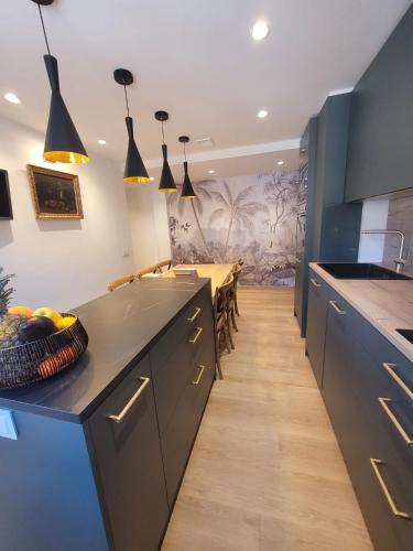 a kitchen with a black counter and a table at Relaxing Time in Candeleda