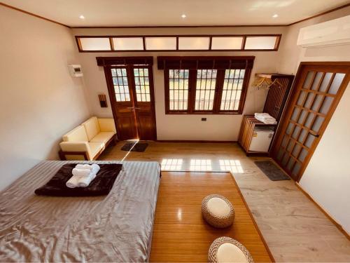 a bedroom with a bed and a couch in a room at MI WO KEZHAN in Ban Rak Thai