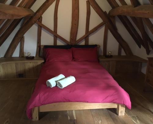 a bedroom with a bed with two towels on it at Farmhouse Gite in Saint-Georges