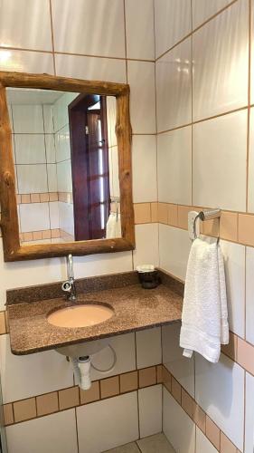 a bathroom with a sink and a mirror at Hotel Salinopolis e kitepoint in Salinópolis