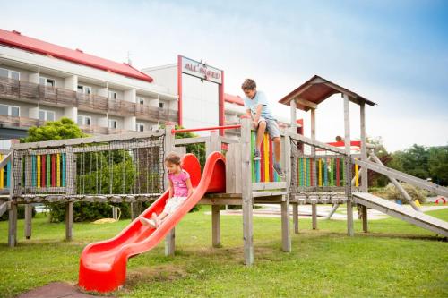 a boy and a girl playing on a playground at All in Red Thermenhotel in Lutzmannsburg