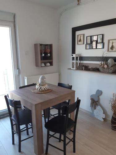 a dining room with a wooden table and chairs at Bela Vila in Negotin