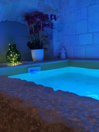a swimming pool with blue lighting in a room at A casòdd' - Luxury Suite in Ceglie Messapica