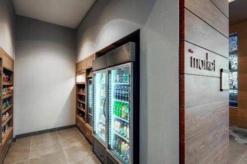 a kitchen with an open refrigerator with drinks at Residence Inn by Marriott Dallas Frisco in Frisco