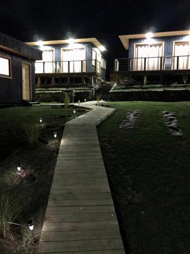 a walkway in front of a house at night at Vistaranco Costanera in Lago Ranco