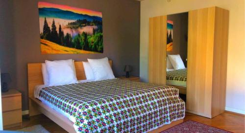 une chambre avec un lit et un tableau au mur dans l'établissement Gîte 