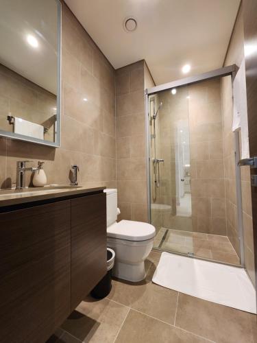 a bathroom with a toilet and a glass shower at STAY BY LATINEM Luxury 1BR Holiday Home CV B905 near Burj Khalifa in Dubai