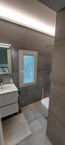 a bathroom with a sink and a toilet and a window at Il Profumo Dellegrazie in Le Grazie