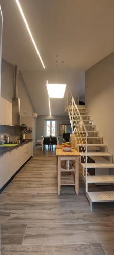 a kitchen with stairs and a table in a room at Il Profumo Dellegrazie in Le Grazie