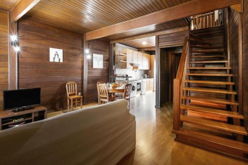 a living room with wood paneling and a staircase at Stylish Rustic Villa in Vau
