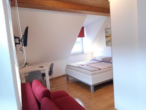 a living room with a bed and a couch at Ferienhaus Würzgarten in Ürzig