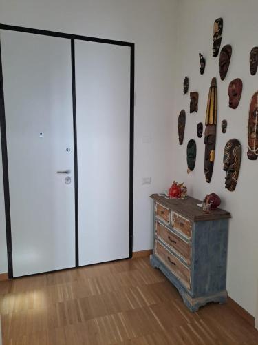 a room with two sliding doors and a wooden dresser at Le Casette in Matera