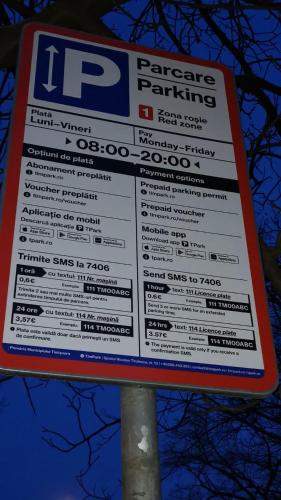 a parking sign sitting on top of a parking lot at Alessia Apartment in the Old Town in Timişoara