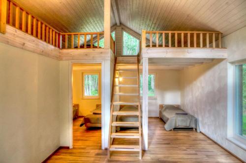 a loft bed in a tiny house at Villa Pillapalu in Pillapalu