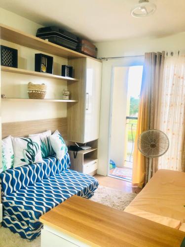 a bedroom with a bed and a door to a patio at CasaMia Studio Sanremo Oasis Cebu in Talisay