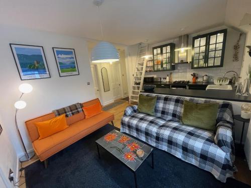 un soggiorno con divano e tavolo di Glen Ness Apartment in tranquil area of city centre a Inverness
