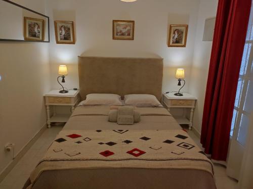 1 dormitorio con 1 cama grande y 2 mesitas de noche en Lemos family beach house, en Nazaré
