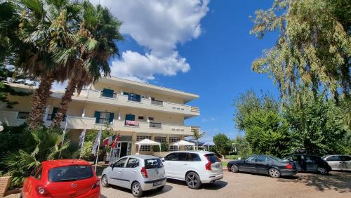 a group of cars parked in front of a building at Apollon Hotel in Ancient Epidavros