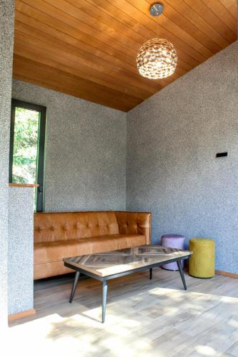 a living room with a couch and a table at Villa Pillapalu in Pillapalu