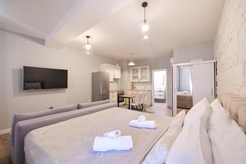 a bedroom with a bed and a living room at Elegance Studio Apartments in Zadar