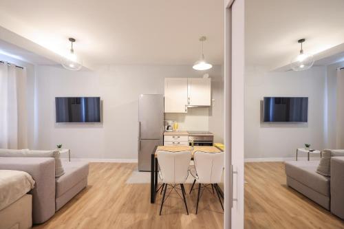 a kitchen and a living room with a table and chairs at Elegance Studio Apartments in Zadar