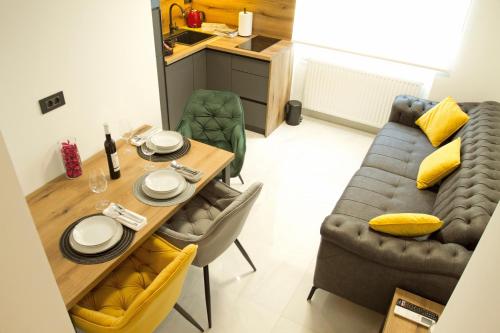 a living room with a table and a couch at Afrodita Wellness Essence in Plitvička Jezera