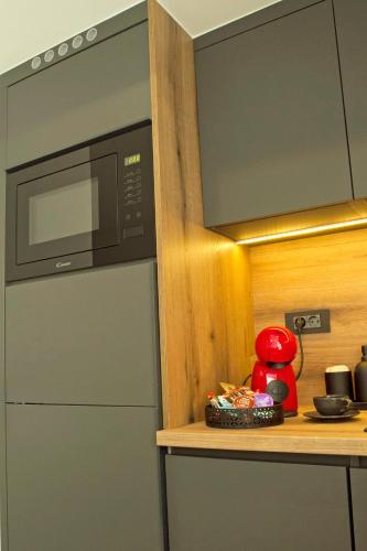 a kitchen with a refrigerator and a microwave at Afrodita Wellness Essence in Plitvička Jezera