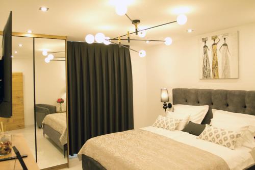 a bedroom with a bed and a black curtain at Afrodita Wellness Essence in Plitvička Jezera