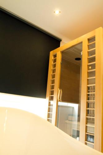 a bathroom with a bath tub and a glass window at Afrodita Wellness Essence in Plitvička Jezera