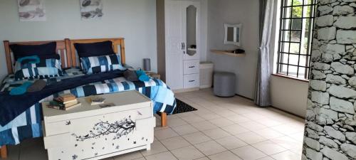 a bedroom with a bed with a blue and white comforter at 74 On Ridge in Bazley Beach