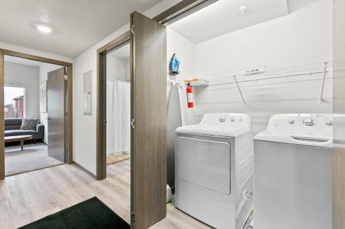 a laundry room with a washer and dryer at HUGE-Fun-Trendy Apt by Perry District & Downtown in Spokane